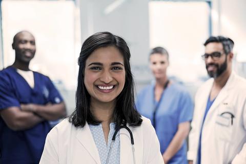 group of providers in lab coats smiling