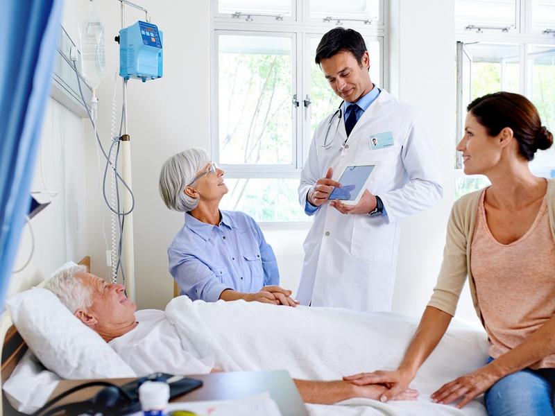 Doctor talking with patient and family